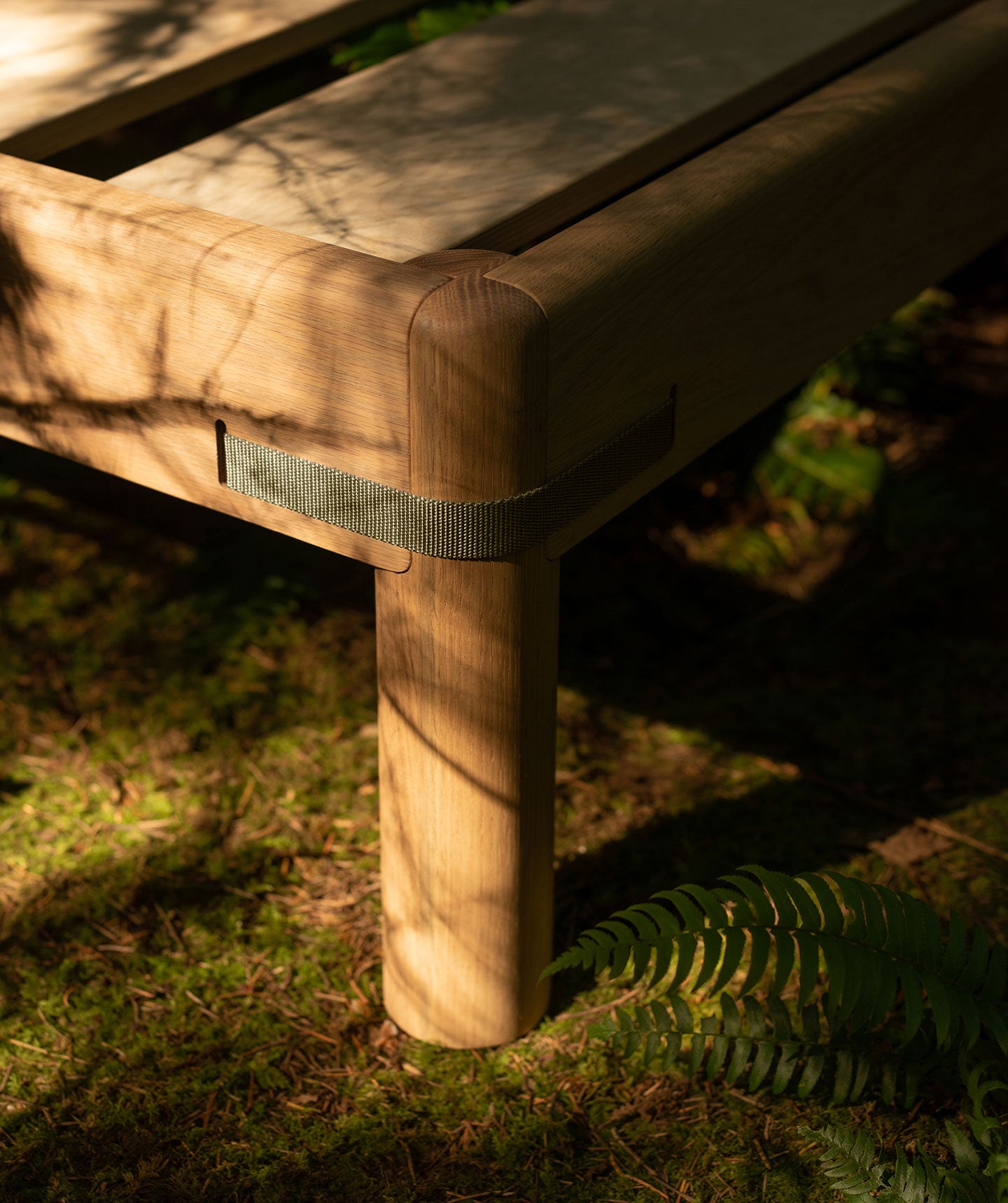 Bed leg with strap