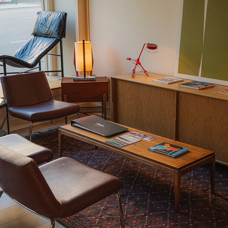 Design Havn's Mid-century Modern interior design with vintage wooden furniture, chairs, and decor items.